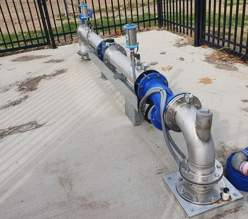 Stainless Steel Pipe With a Blue Hose Attached to It — Peel Irrigation & Water Supplies in Taminda, NSW