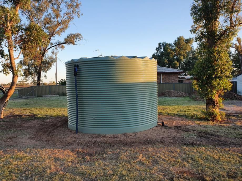 Large Green Water Tank is Sitting in the Middle of a Grassy Field — Peel Irrigation & Water Supplies in Taminda, NSW