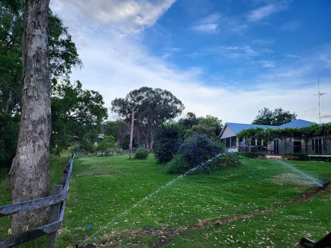 Large Grassy Field With a House — Peel Irrigation & Water Supplies in Narrabri, NSW