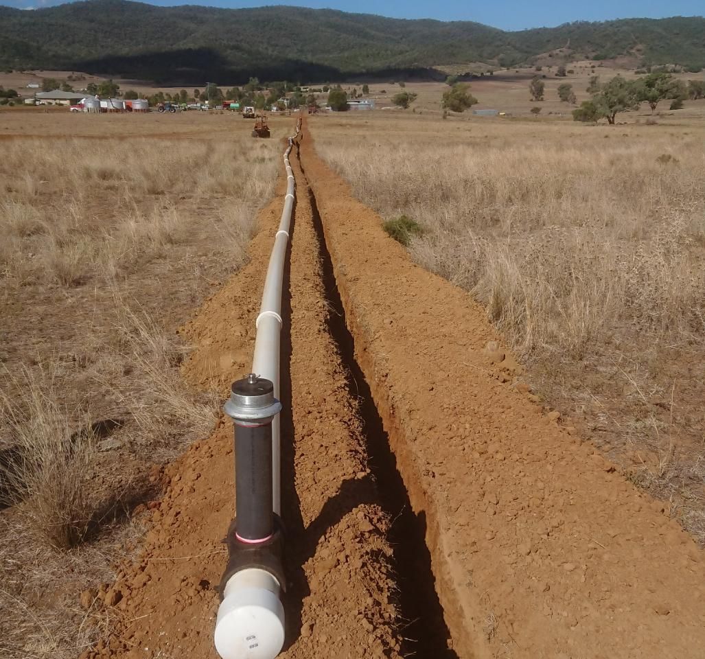 Pipe in the Middle of a Dirt Field With Mountains — Peel Irrigation & Water Supplies in Taminda, NSW