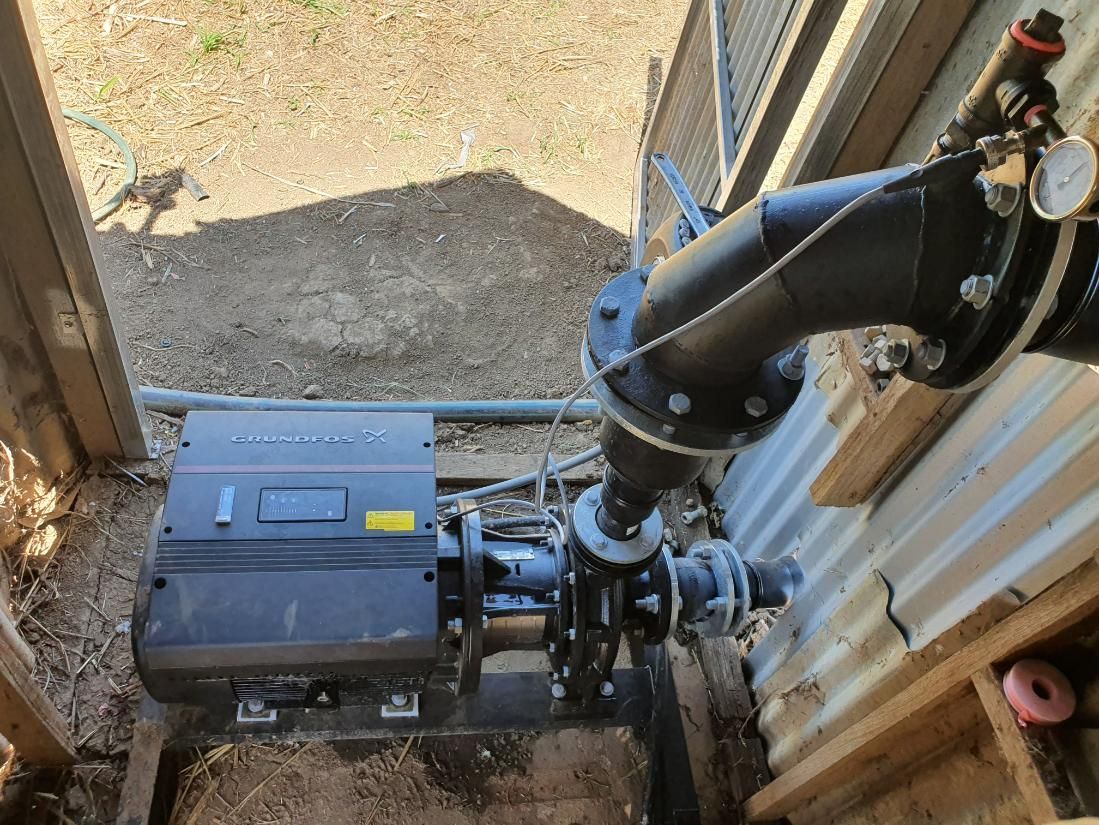 Black Pipe is Connected to a Black Pump in a Room — Peel Irrigation & Water Supplies in Gunnedah, NSW