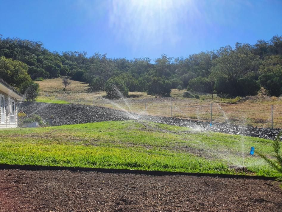 Sprinkler is Spraying Water on a Lush Green Field — Peel Irrigation & Water Supplies in Gunnedah, NSW