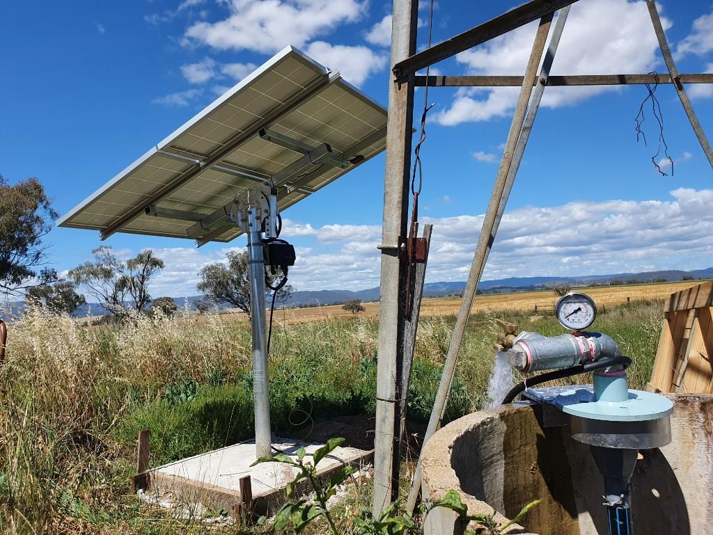 Solar Panel is Sitting Next to a Water Pump in a Field — Peel Irrigation & Water Supplies in Gunnedah, NSW