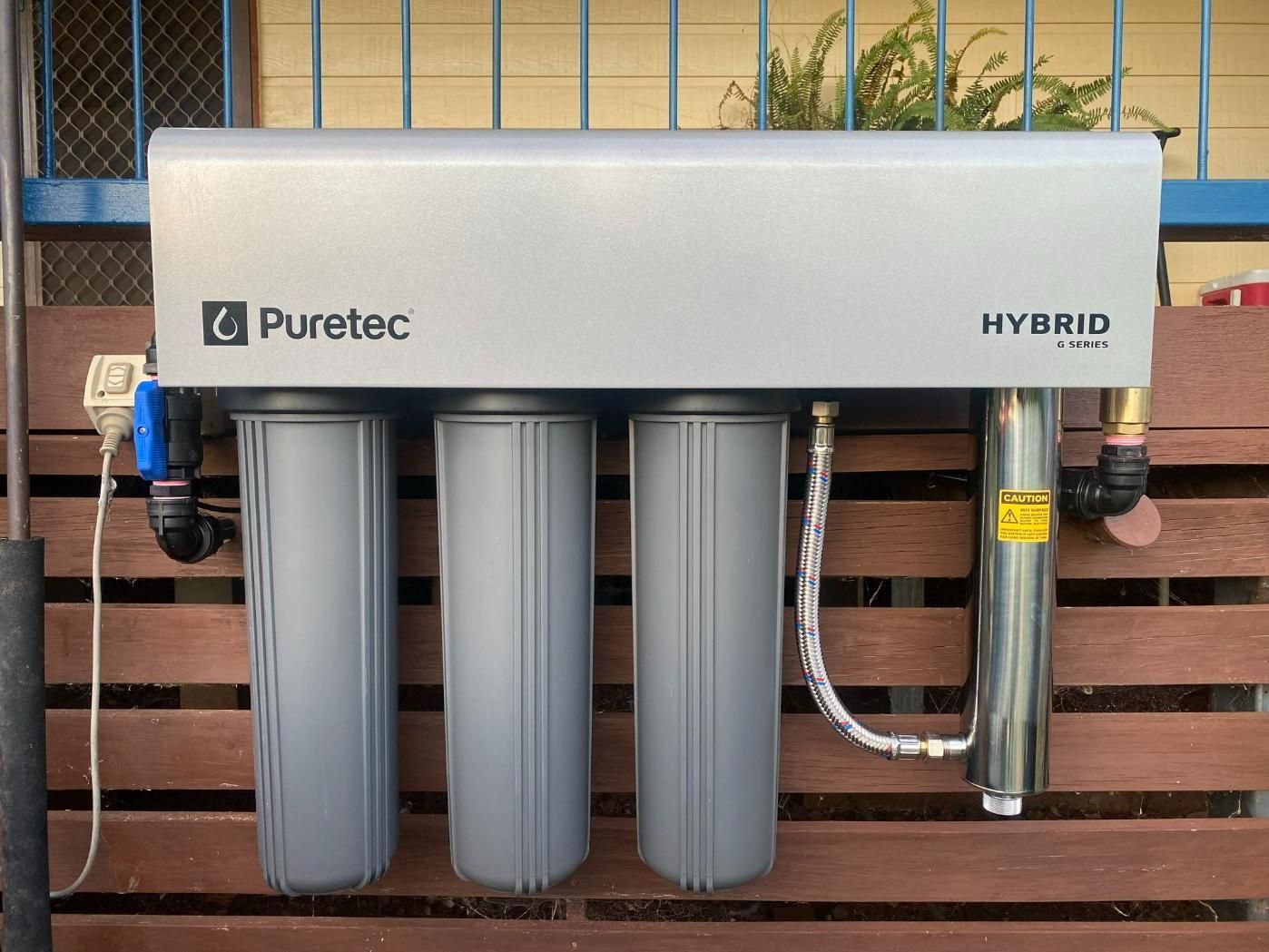 Puretec Hybrid Water Filter is Attached to a Wooden Fence — Peel Irrigation & Water Supplies in Gunnedah, NSW
