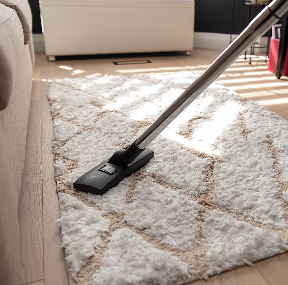 a member of the sparkling green team cleaning the floor of the office