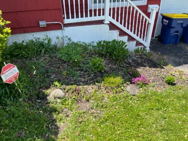 A red house with white stairs and a sign that says no parking in front of it.