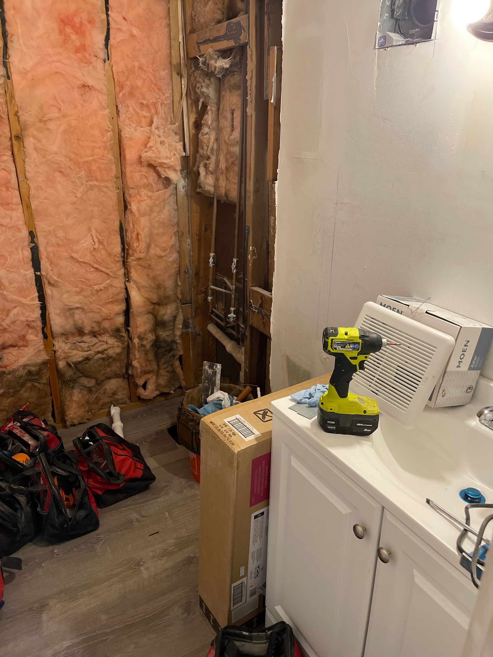 A bathroom with a sink and a drill in it.