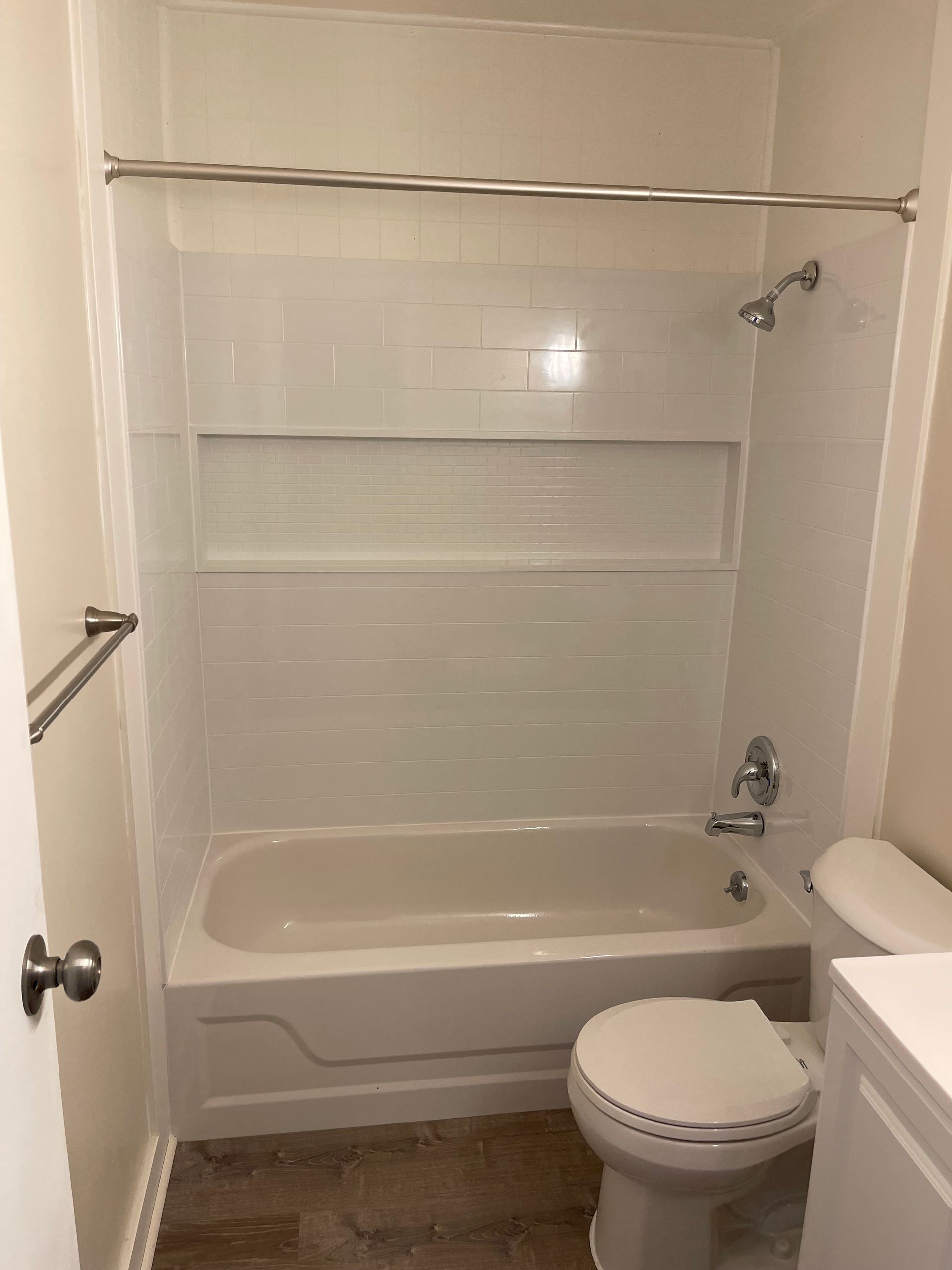 A bathroom with a bathtub , toilet , and sink.