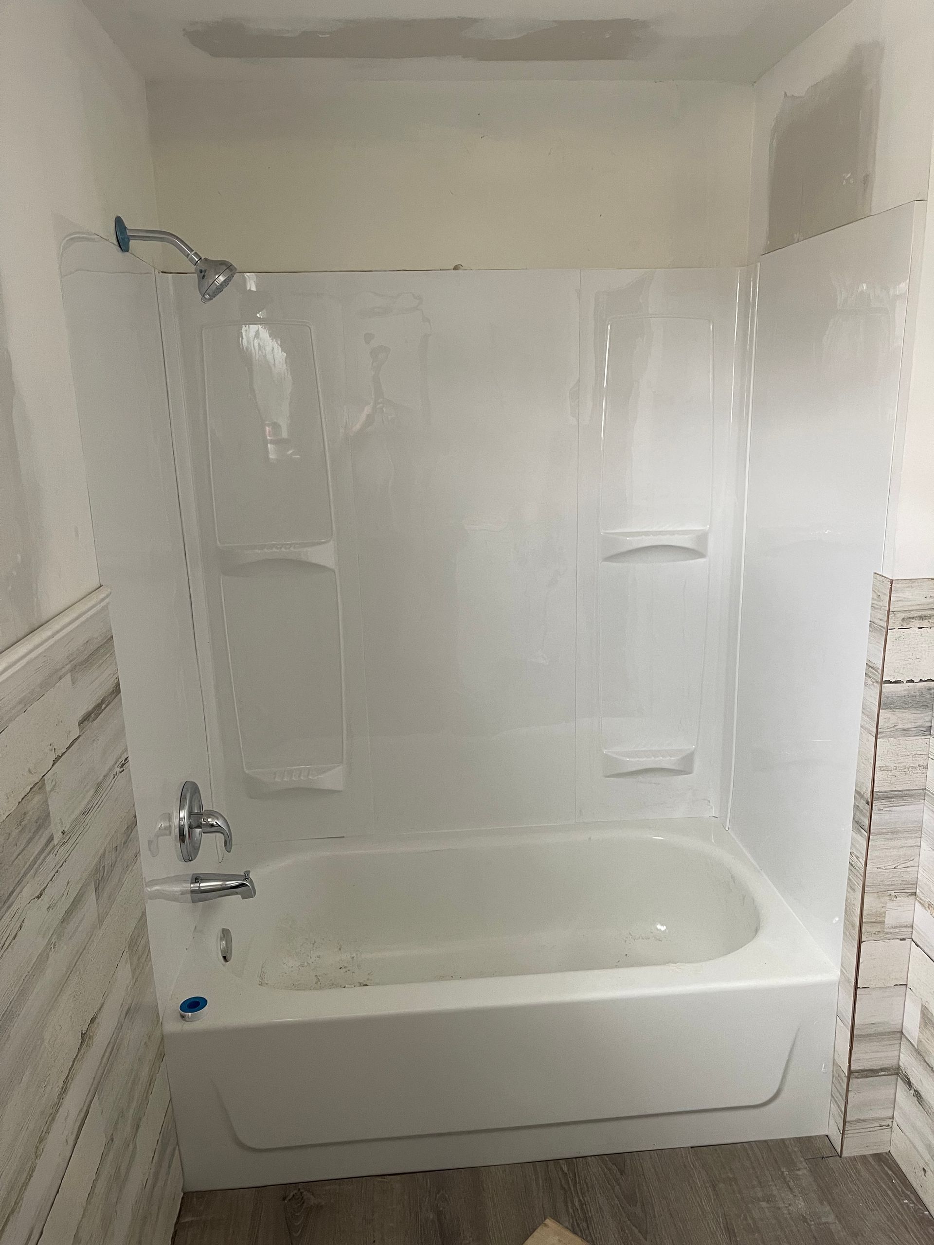 A bathroom with a bathtub and a shower.