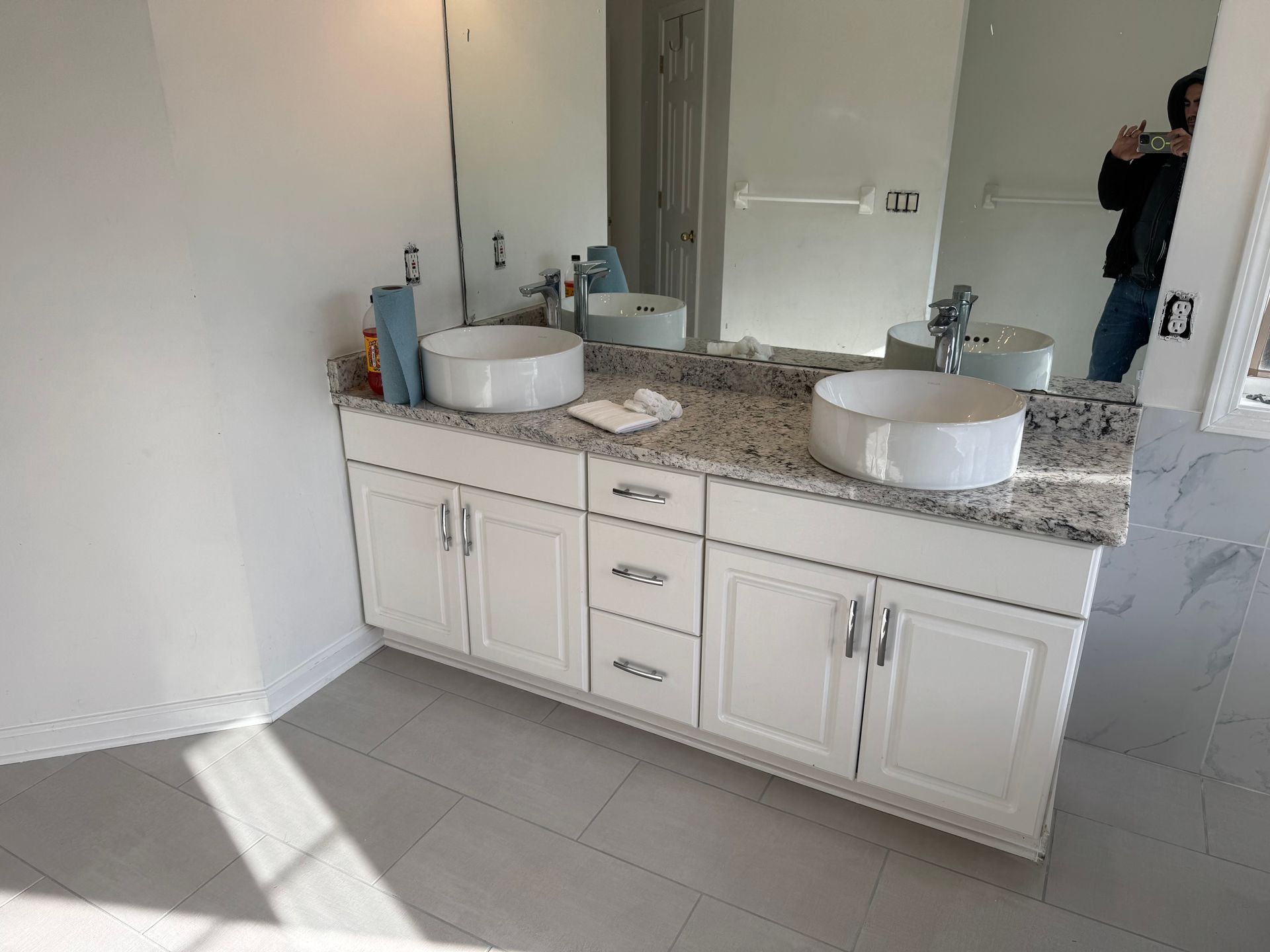 A bathroom with two sinks and a large mirror.