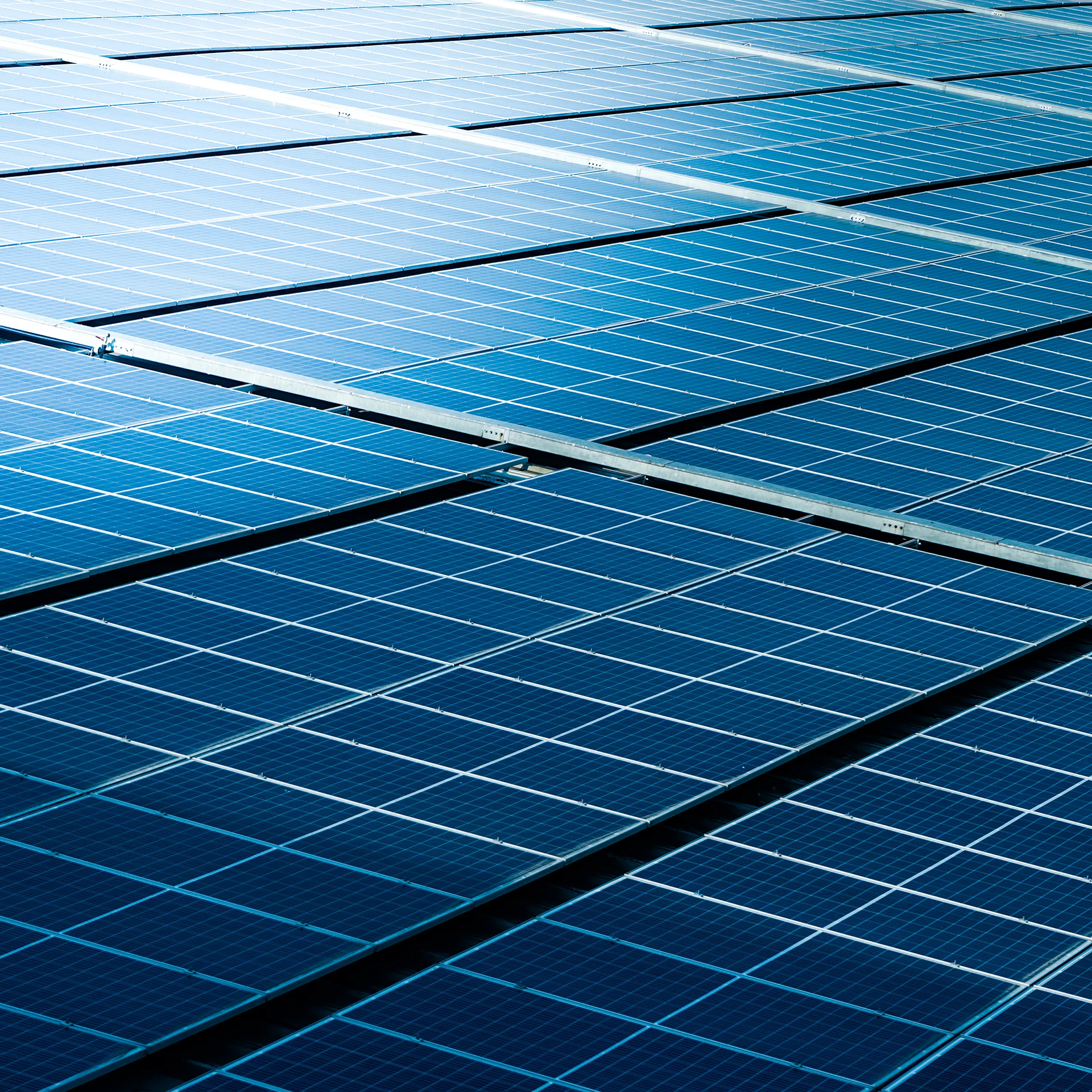 Solar panel array, blue grid pattern, outdoors.