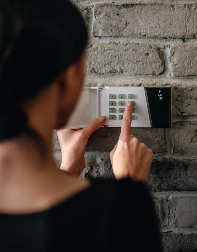 Woman Setting Burglar Alarm — Sonbert Security Systems Inc. — Winston Salem, North Carolina