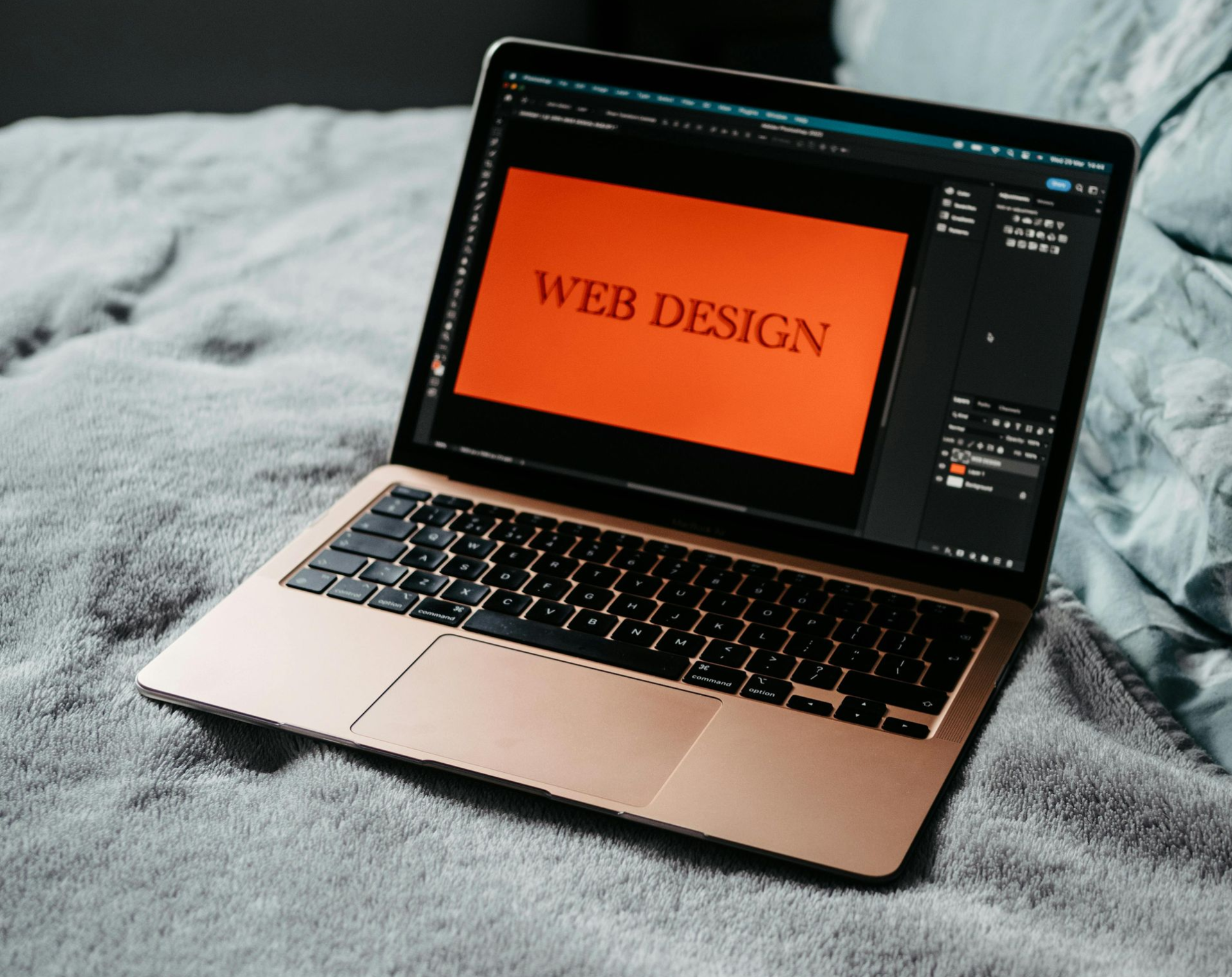 laptop on bed displaying web design