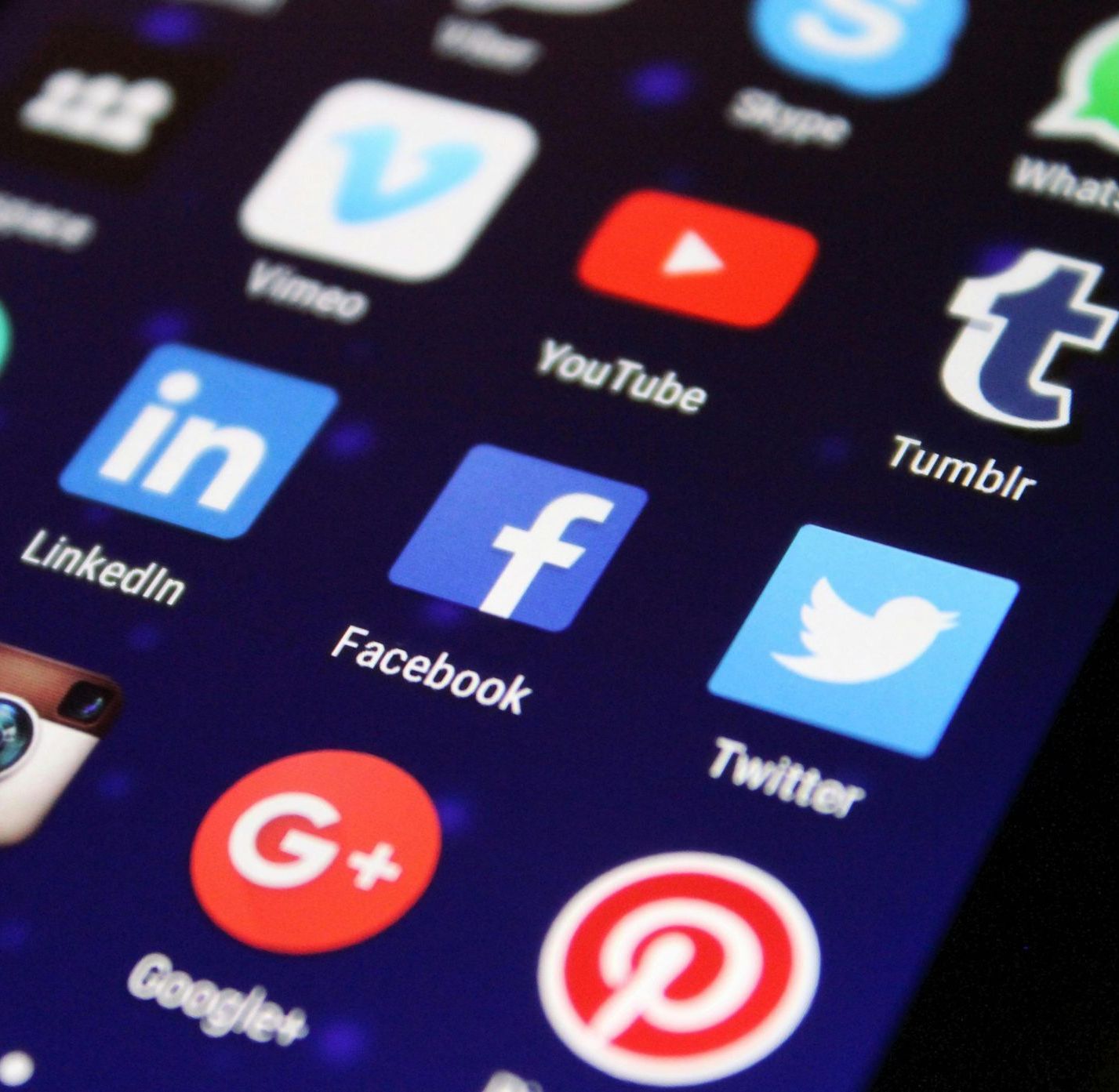 A close up of a cell phone screen with social media icons