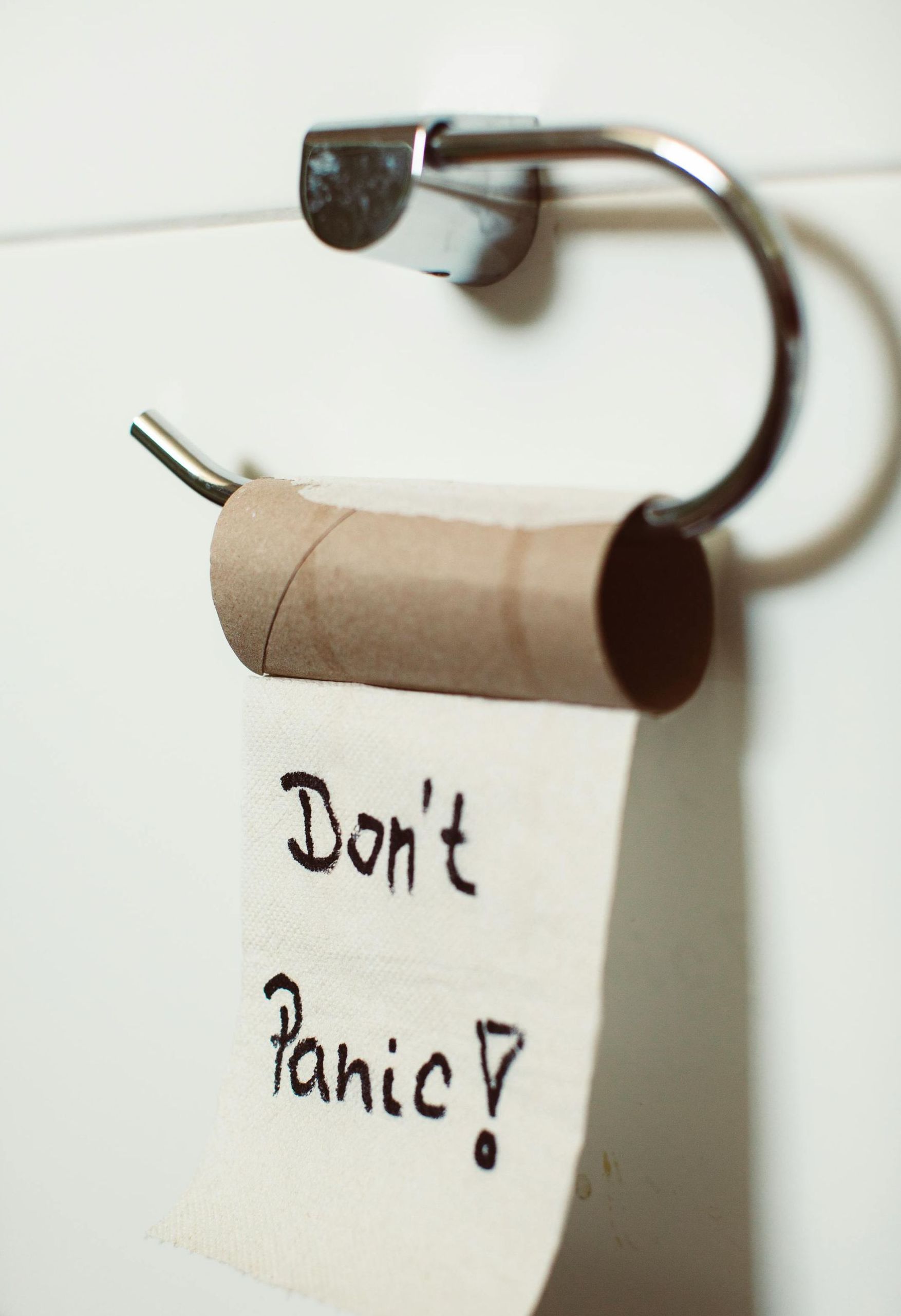 An empty roll of toilet paper with the words 