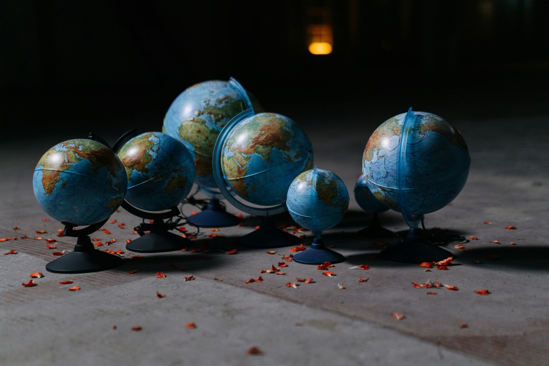 six spinning globes placed on a deck