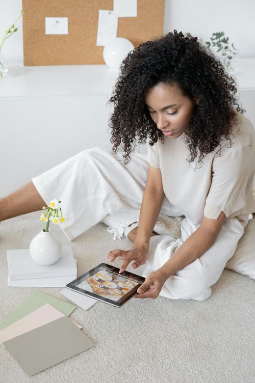 woman on floor working on tablet