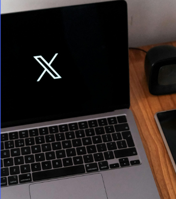 X logo on laptop