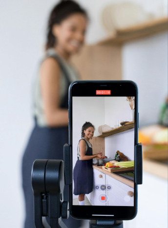 woman posting on Social Media while cooking