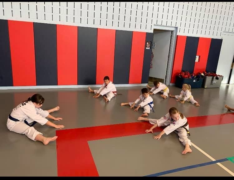 A person is holding a sparkler in their hand in the dark.