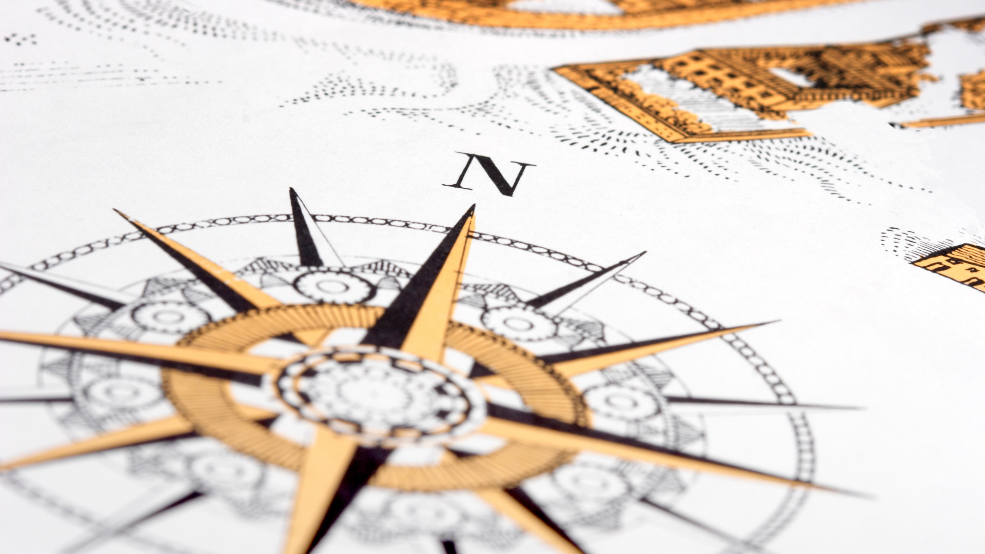 A close up of a compass pointing to the north on a map.