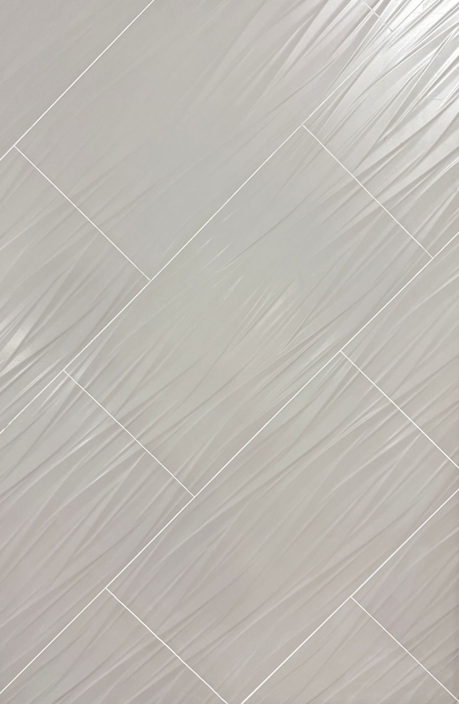 A white tile with a black frame is sitting on a table.