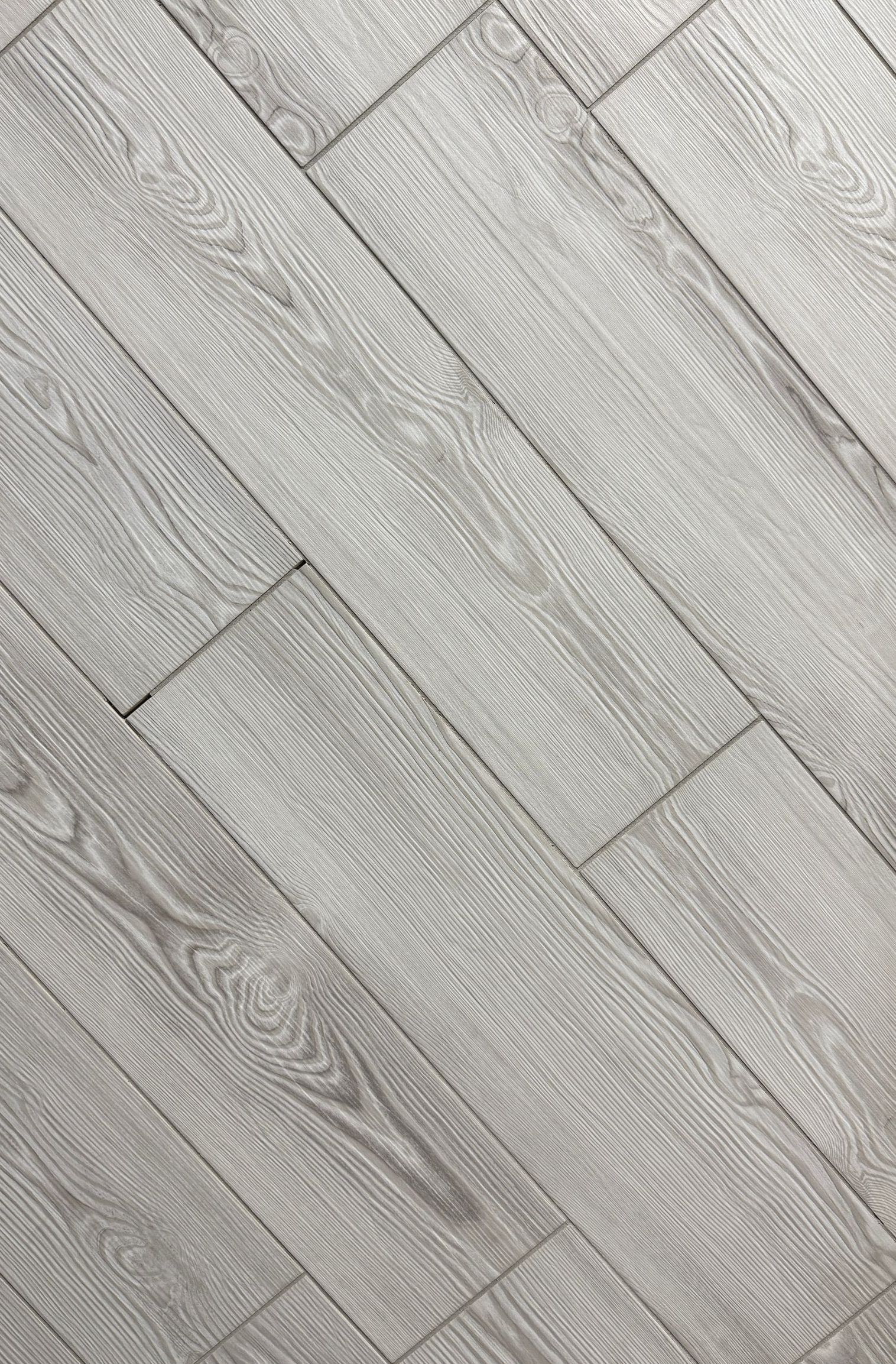 A close up of a wooden floor with a diagonal pattern.