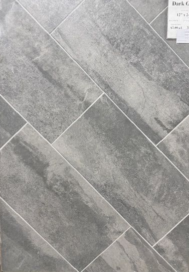 A close up of a gray tile floor that looks like wood.