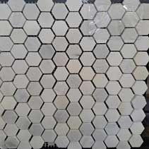 A close up of a white hexagon mosaic tile.