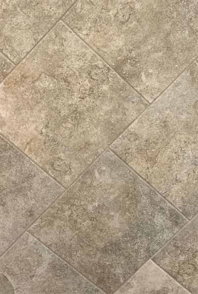 A close up of a tile floor with a diagonal pattern.