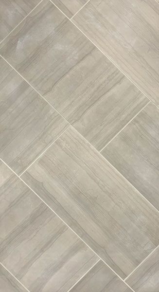 A close up of a tile floor that looks like wood.