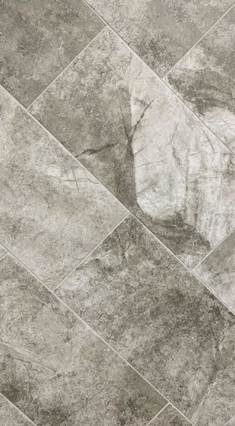 A close up of a gray tile floor with a diagonal pattern.