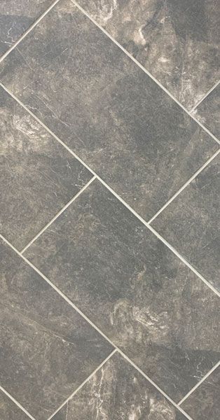 A close up of a gray tile floor with white grout.