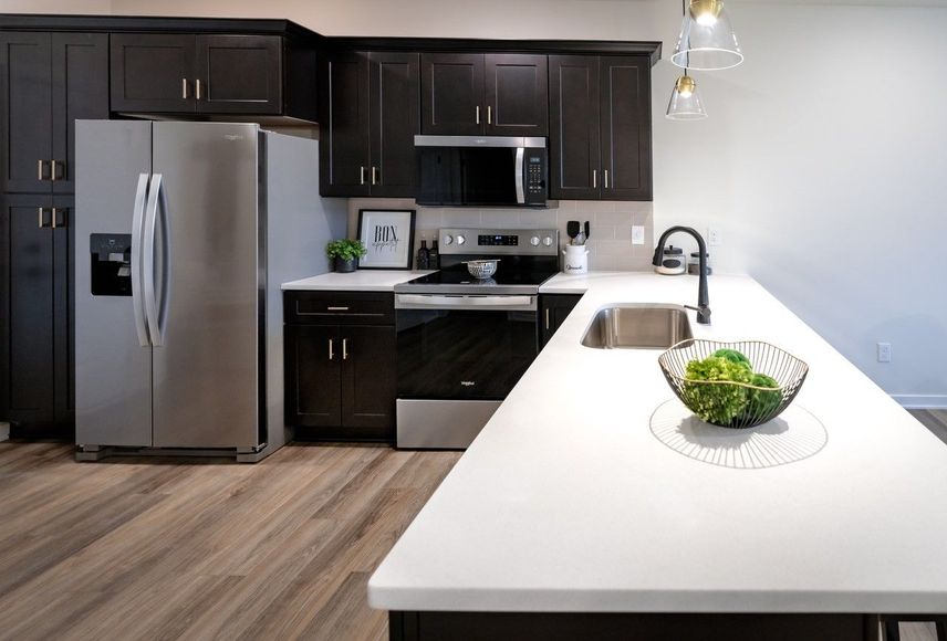 A kitchen with stainless steel appliances and granite counter tops
