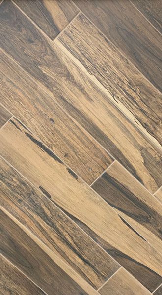 A close up of a wooden floor with a diagonal pattern.