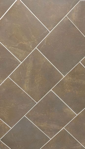 A close up of a brown tile floor with white grout.