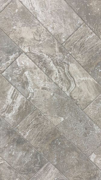 A close up of a gray tile floor.