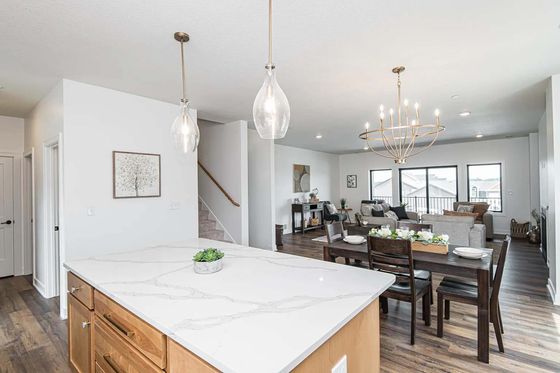 A kitchen with a large island and a dining table.