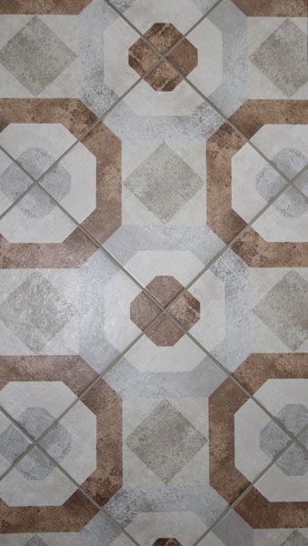 A close up of a tile floor with a geometric pattern.