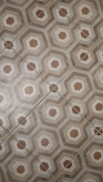 A close up of a tile floor with a hexagon pattern.