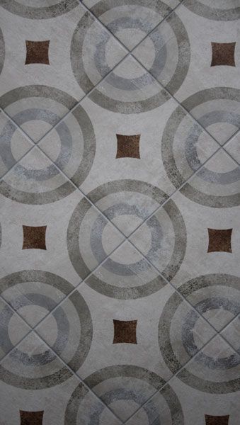 A close up of a tile floor with circles and squares on it.