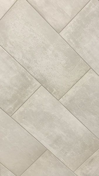 A close up of a white tile floor with a diagonal pattern.