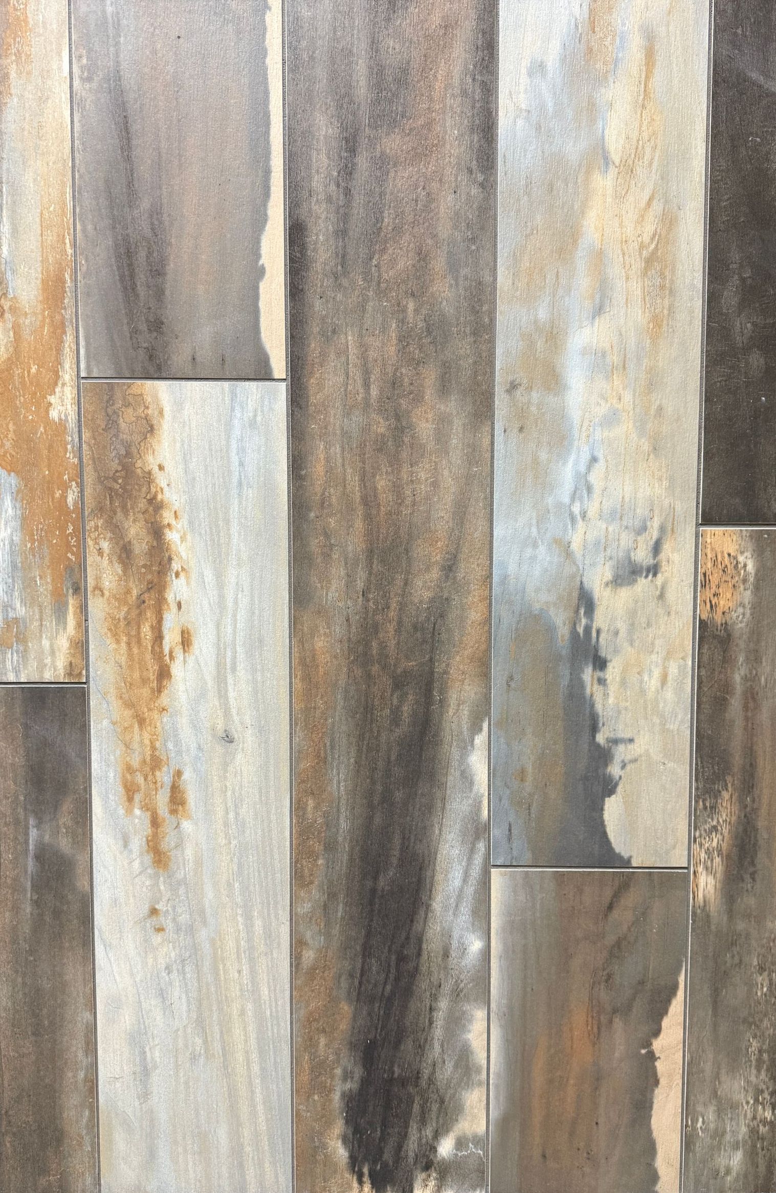 A tile that looks like wood is sitting on a table.