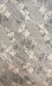 A close up of a tile floor with a pattern on it.