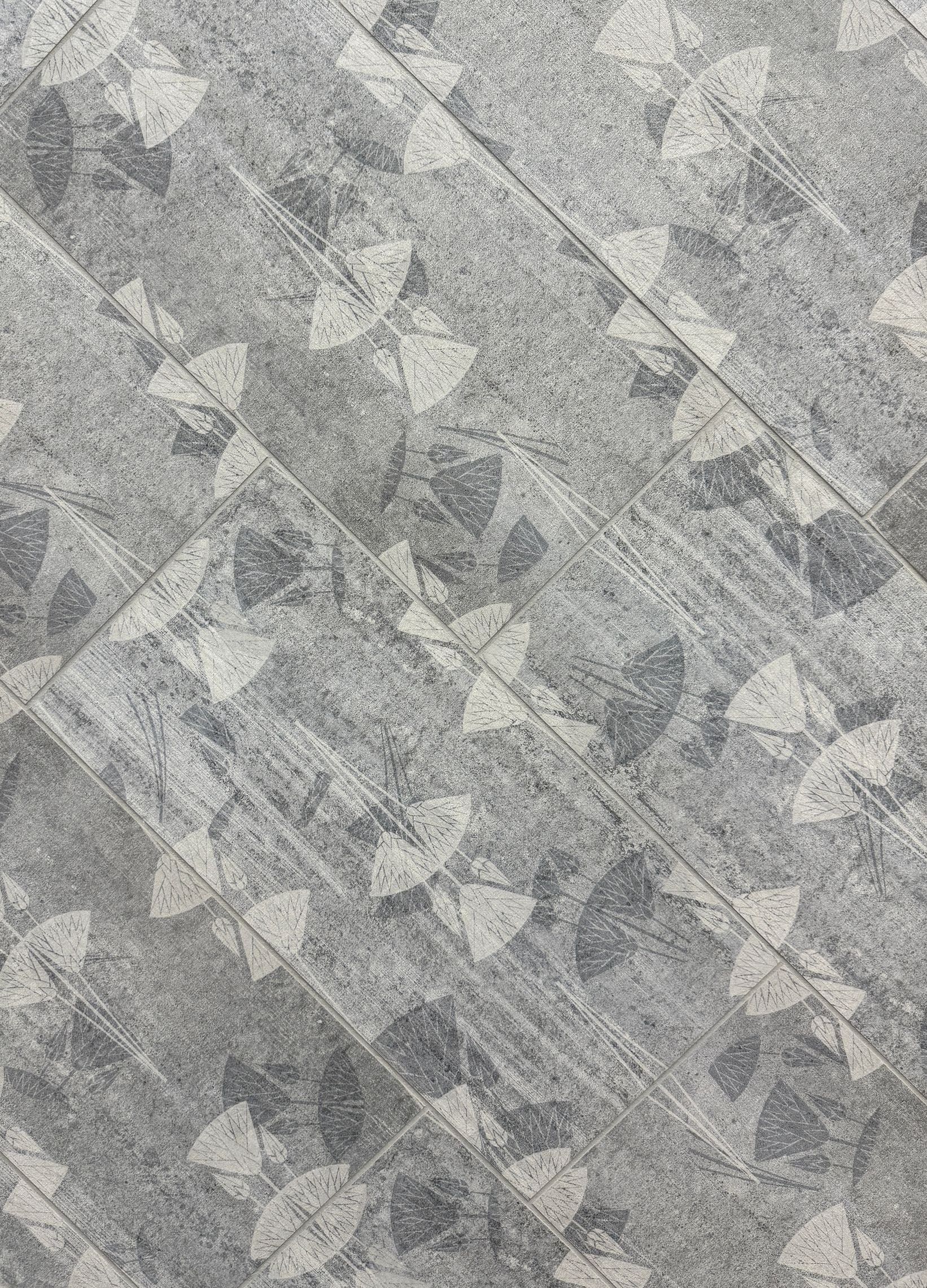 A close up of a tile floor with a pattern on it.