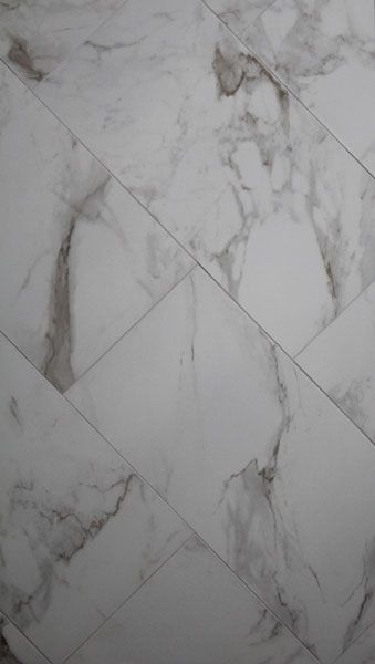 A close up of a marble floor with a gray background.