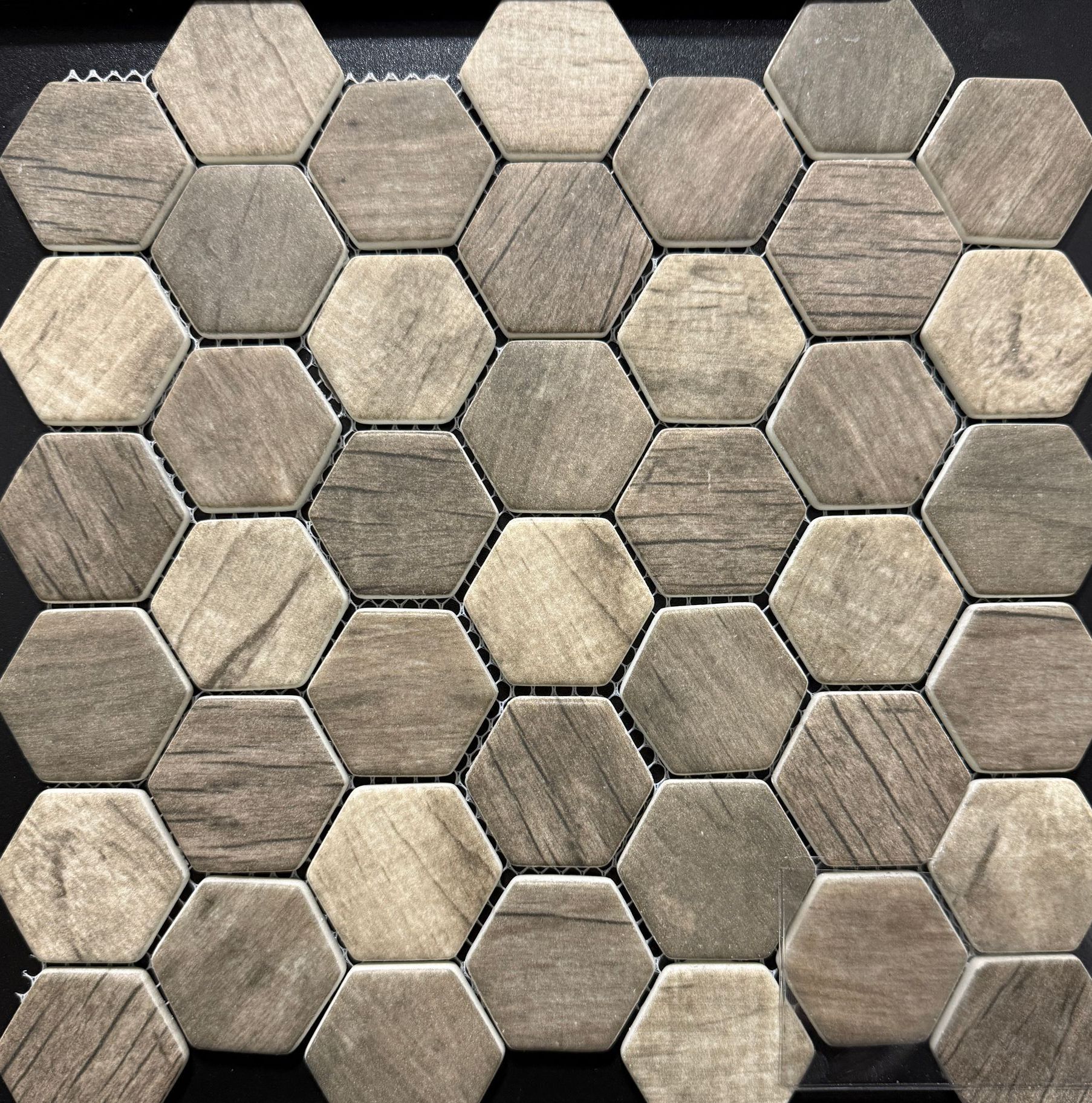 A close up of a tile that looks like honeycombs