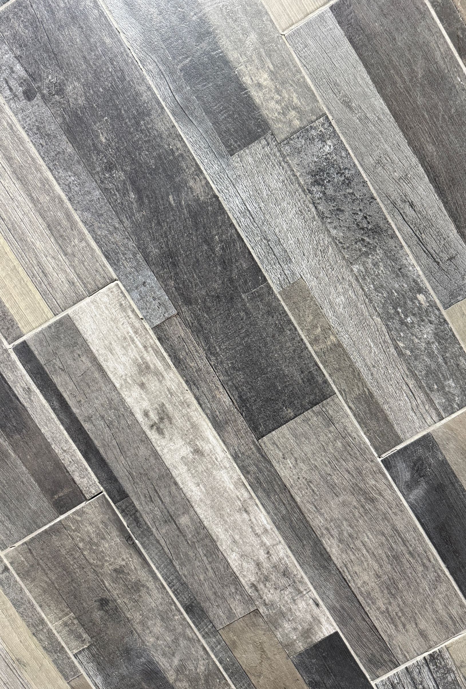 A close up of a gray and black tile floor.