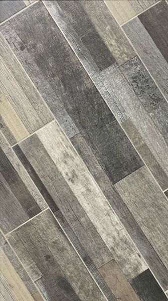 A close up of a tile floor that looks like wood.