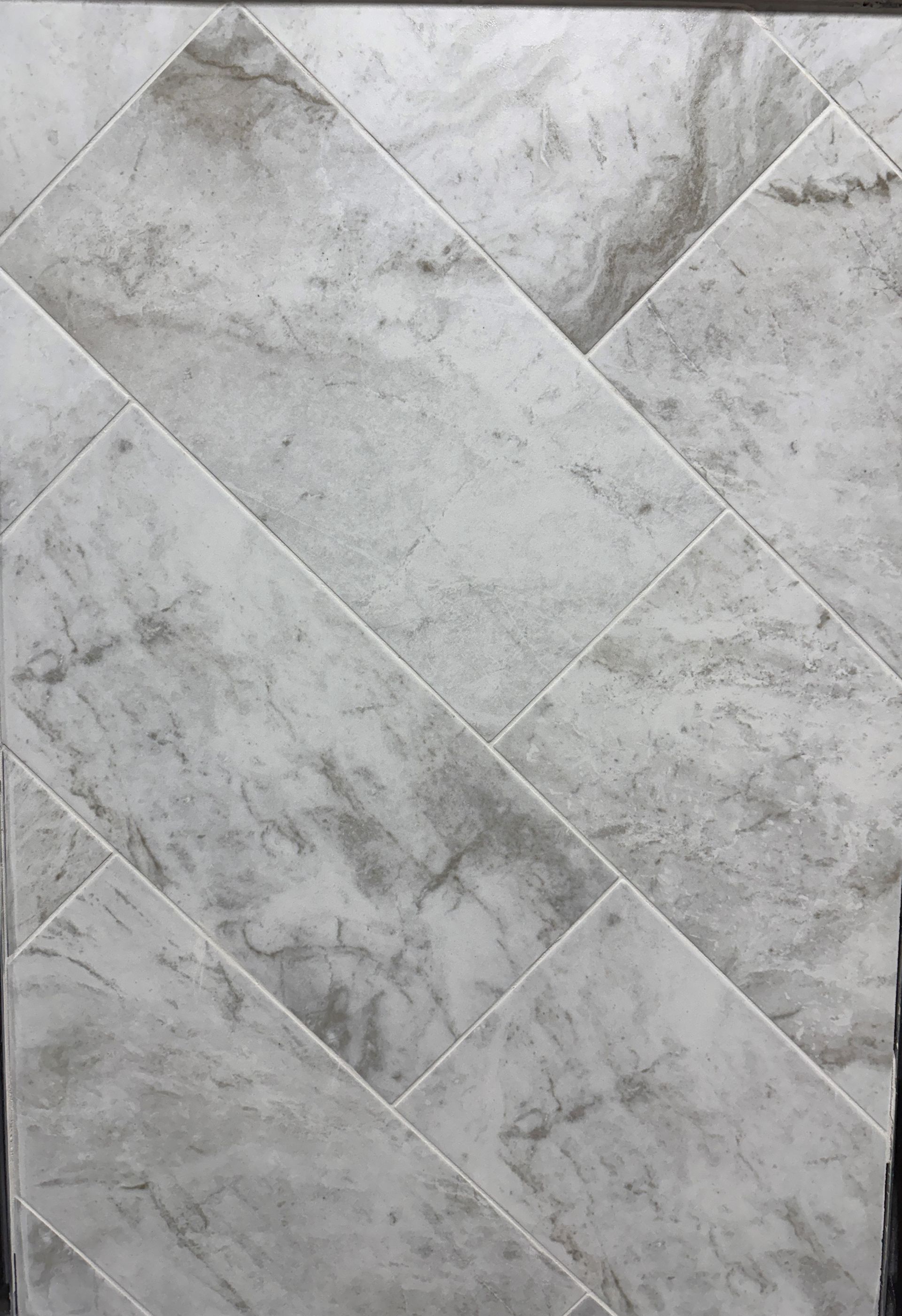 A close up of a white marble tile floor.